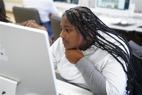 WEB DESIGN & INTERACTIVE MEDIA students working on computers
